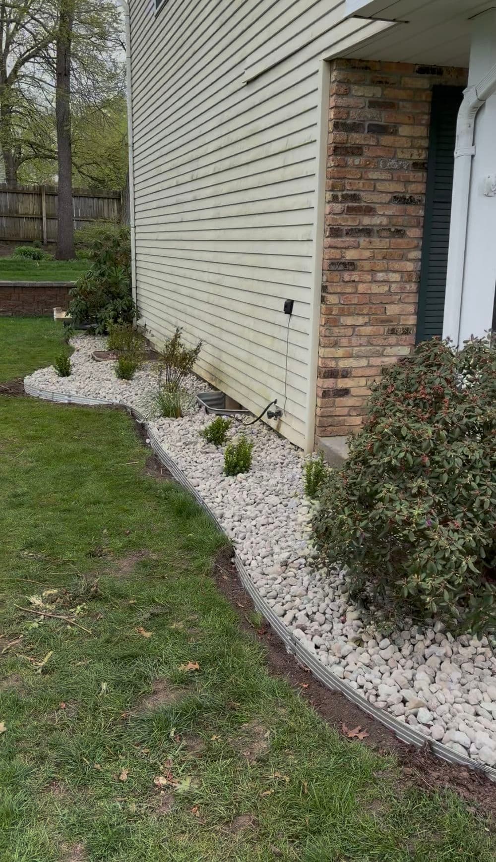 Full Garden Bed Redesign with River Rock and Metal Edging in Portage image