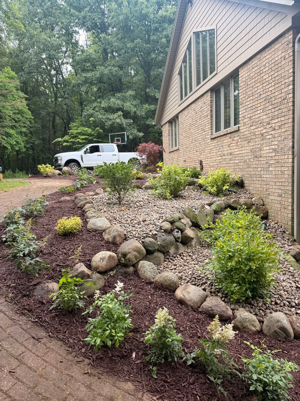 Full Garden Bed Overhaul with Boulders and New Plantings in Kalamazoo